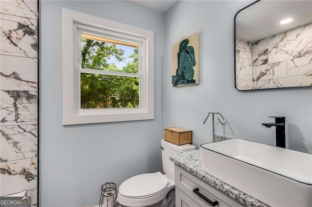 bathroom featuring vanity and toilet