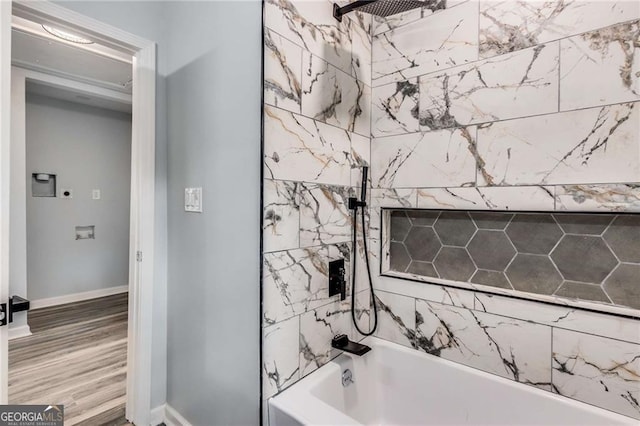 bathroom featuring hardwood / wood-style flooring and tiled shower / bath combo