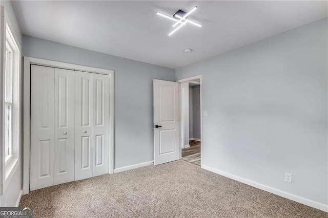 unfurnished bedroom with a closet and carpet