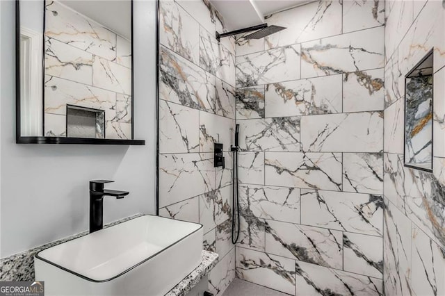 bathroom featuring sink and a tile shower