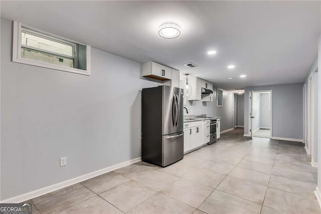 kitchen with stainless steel appliances, white cabinetry, sink, and light tile patterned flooring