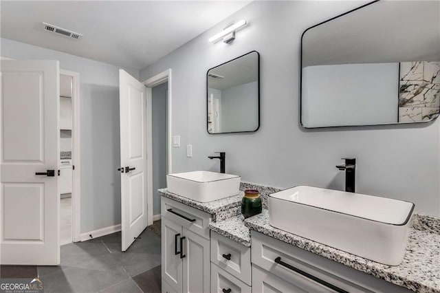 bathroom with tile patterned floors and vanity