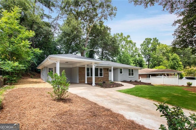 ranch-style home with a carport and a front yard