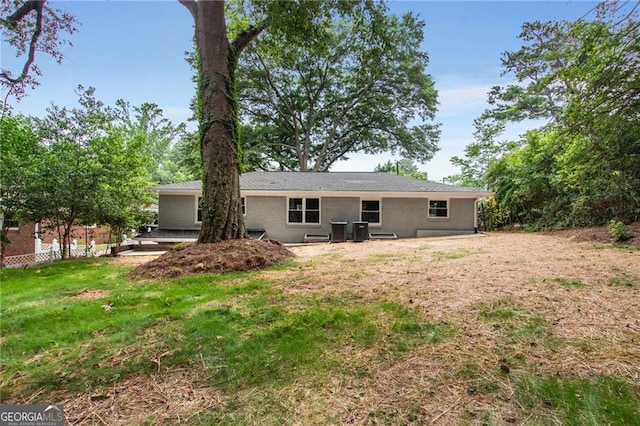 rear view of house featuring a yard