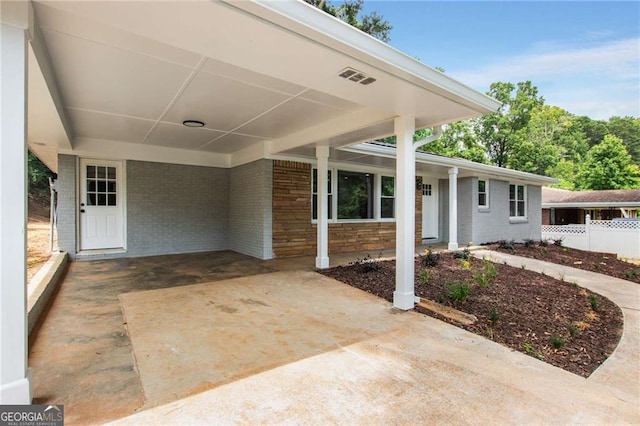 doorway to property featuring a carport