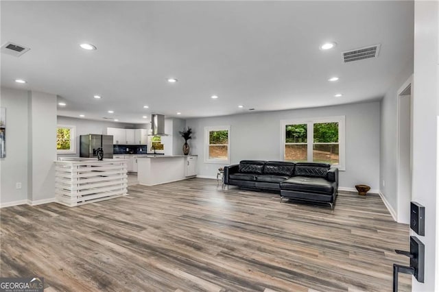 living room with sink and light hardwood / wood-style floors