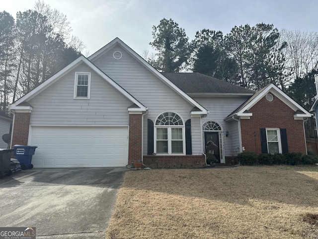 view of front of property featuring a garage and a front yard