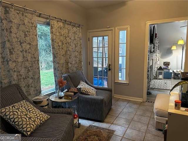 sitting room with a fireplace and light tile patterned floors