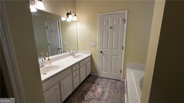 bathroom featuring vanity, a bathing tub, and wood-type flooring