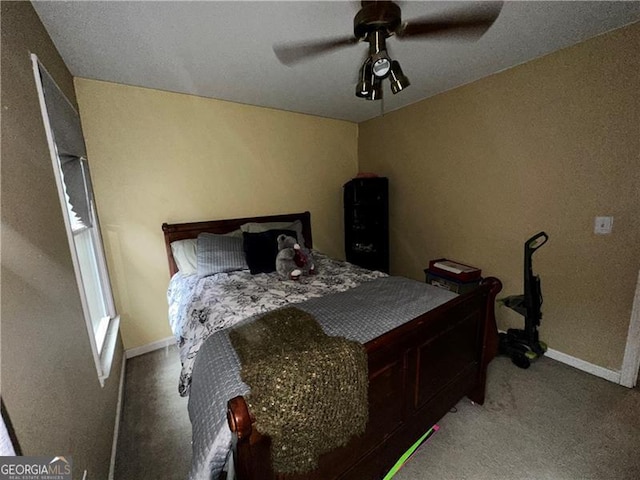 bedroom with ceiling fan and carpet floors