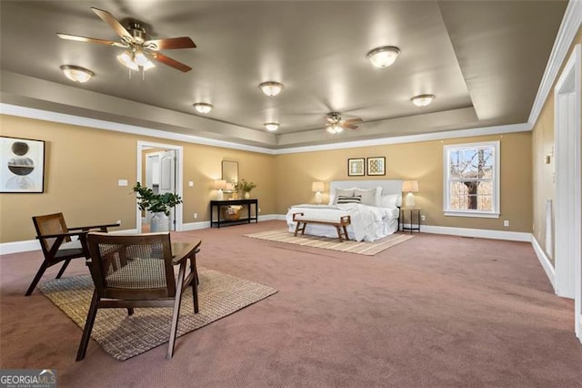 carpeted bedroom featuring ceiling fan and a tray ceiling