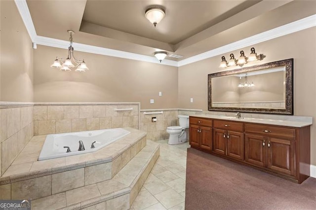 bathroom with a raised ceiling, vanity, a relaxing tiled tub, and toilet