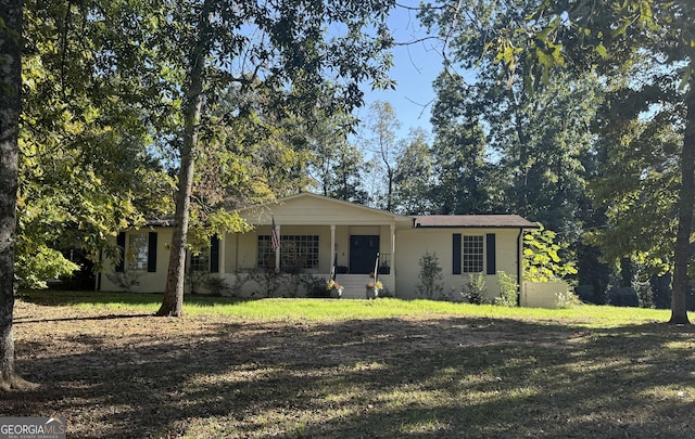 ranch-style home with a front yard and a porch