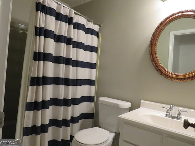 bathroom with vanity, toilet, and curtained shower