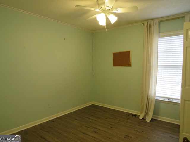 unfurnished room featuring ceiling fan, ornamental molding, and dark hardwood / wood-style floors