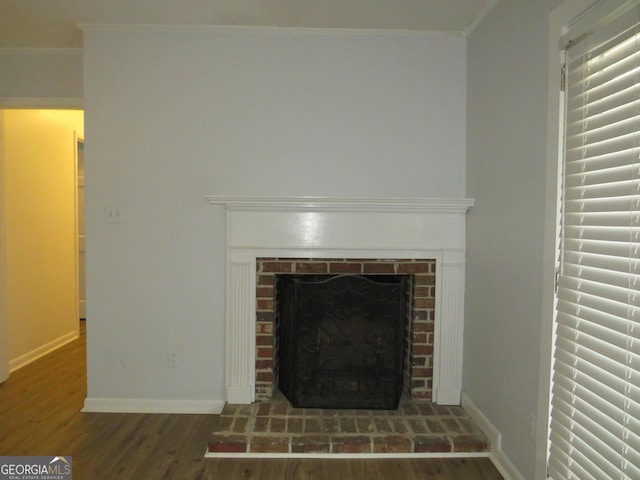 room details with crown molding, a brick fireplace, and hardwood / wood-style flooring