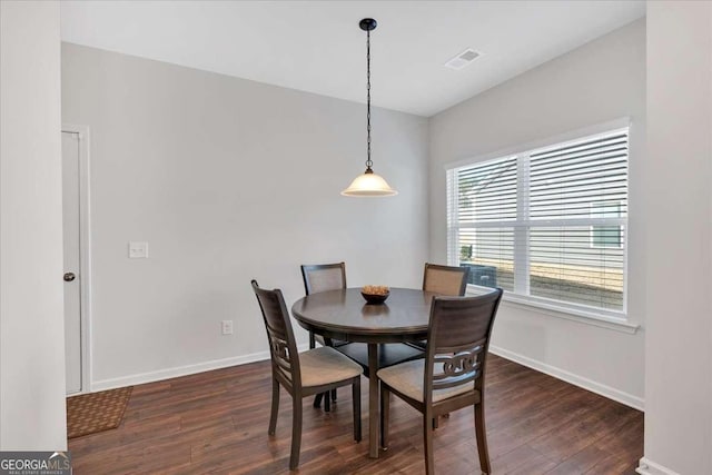 dining space featuring dark hardwood / wood-style flooring