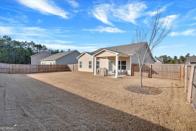 rear view of property featuring a patio area