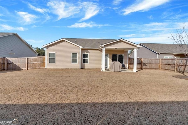 back of house featuring a yard and a patio area