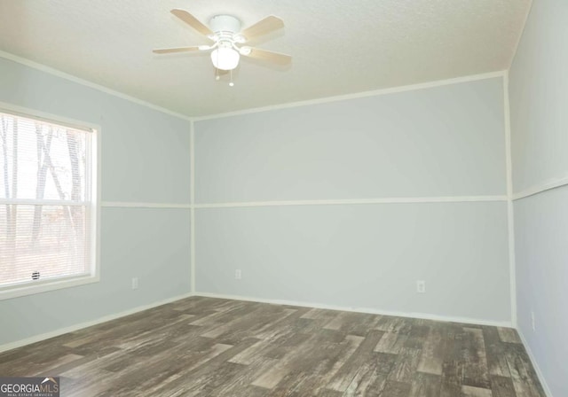 unfurnished room with dark wood-type flooring, ornamental molding, and ceiling fan