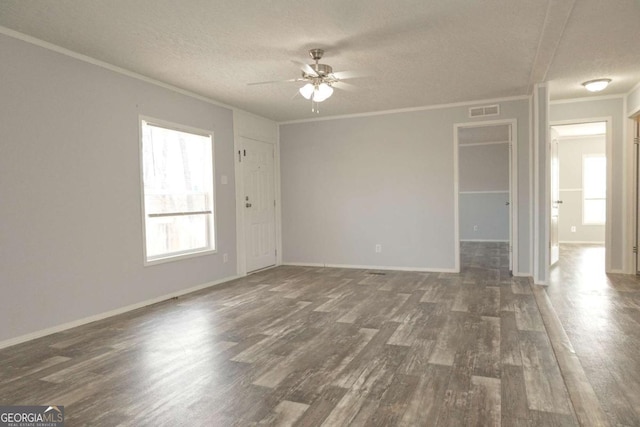 spare room with ornamental molding, ceiling fan, a textured ceiling, and dark hardwood / wood-style flooring