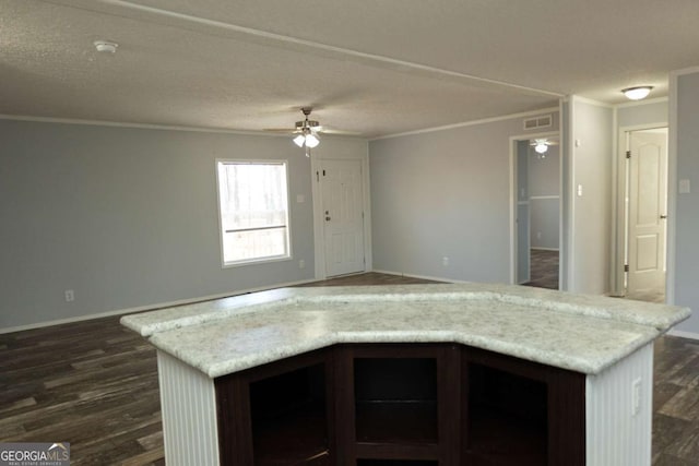 kitchen with ceiling fan, ornamental molding, dark hardwood / wood-style flooring, and a center island