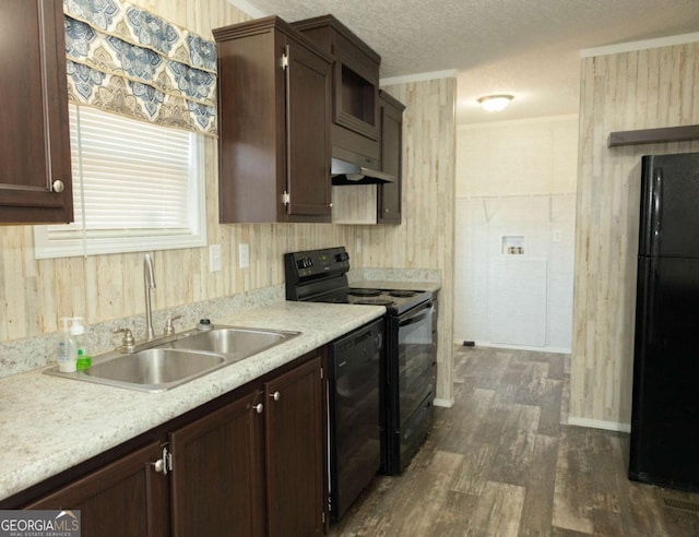 kitchen featuring sink, dark wood-type flooring, dark brown cabinetry, black appliances, and a textured ceiling