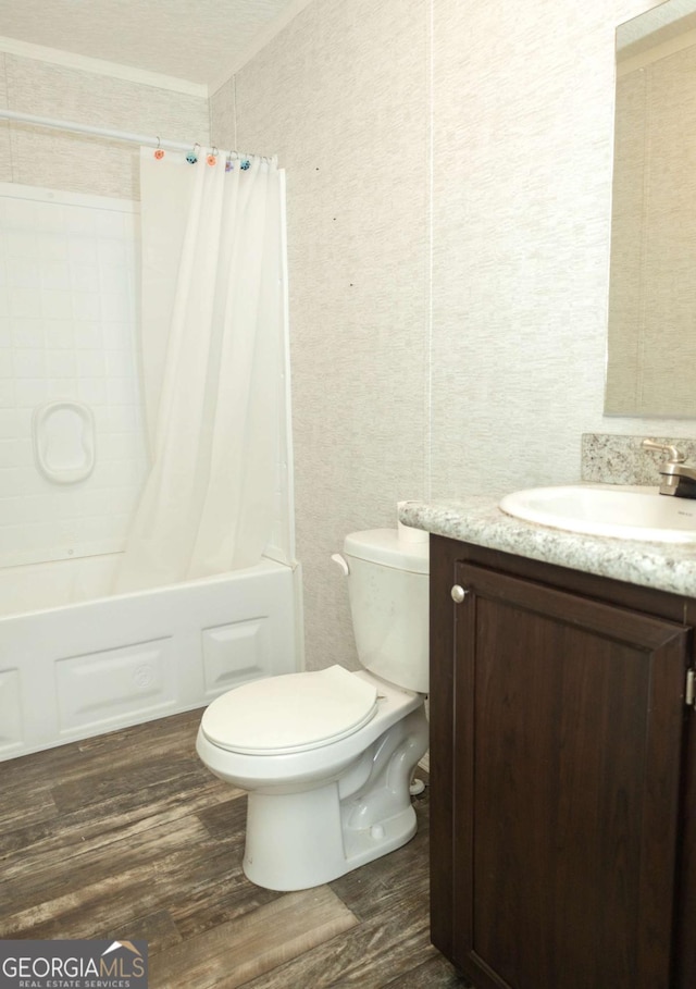 full bathroom with vanity, hardwood / wood-style floors, shower / bath combo with shower curtain, and toilet