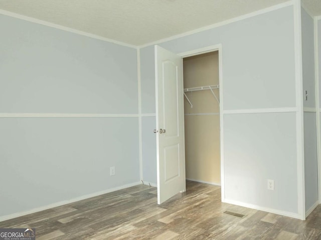 unfurnished bedroom featuring hardwood / wood-style floors