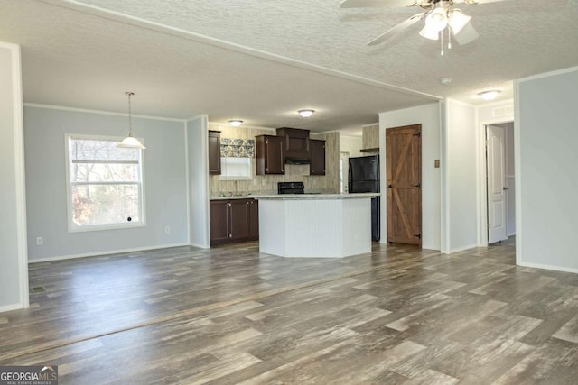 kitchen featuring a kitchen island, pendant lighting, wood-type flooring, crown molding, and dark brown cabinets