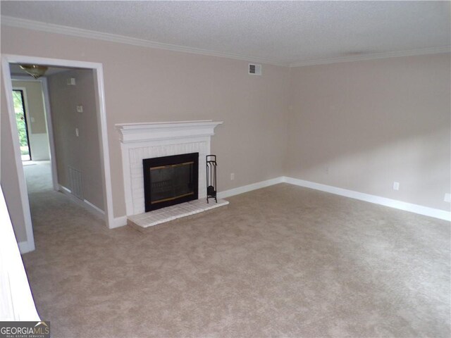 unfurnished living room featuring crown molding, a brick fireplace, light colored carpet, and a textured ceiling