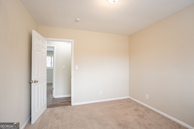 spare room with light colored carpet