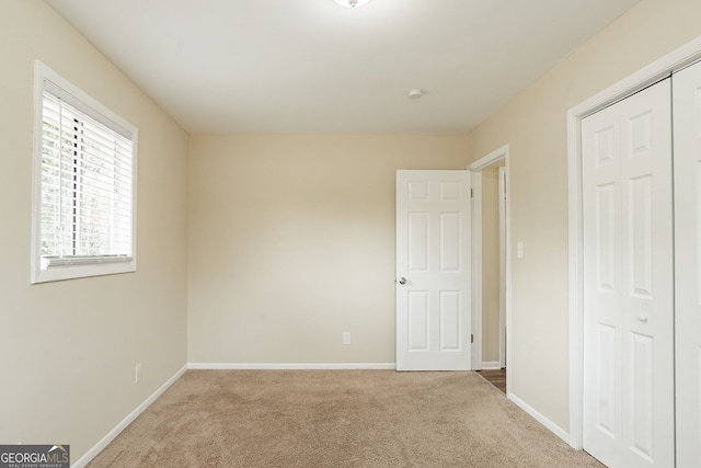 unfurnished bedroom with carpet flooring and a closet