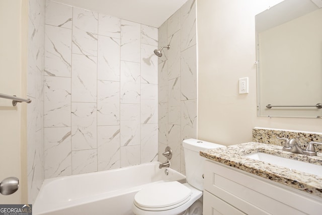 full bathroom featuring vanity, tiled shower / bath, and toilet