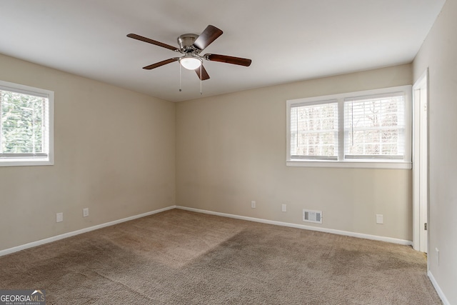 carpeted empty room featuring ceiling fan