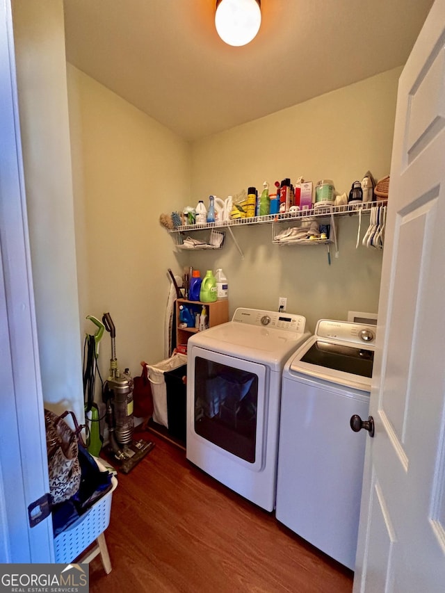 laundry area featuring dark wood-type flooring and independent washer and dryer