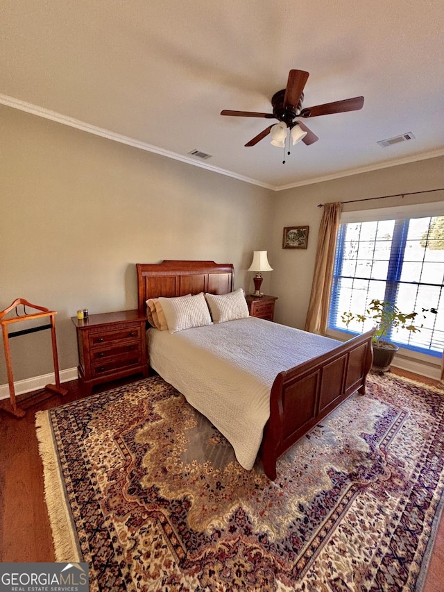 bedroom featuring hardwood / wood-style flooring, ceiling fan, and ornamental molding