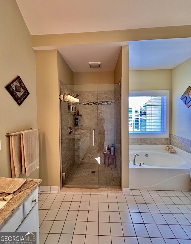 bathroom featuring vanity, shower with separate bathtub, and tile patterned floors