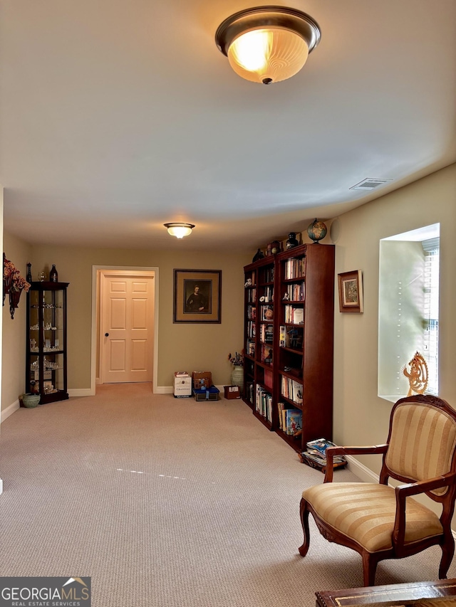 living area featuring light carpet