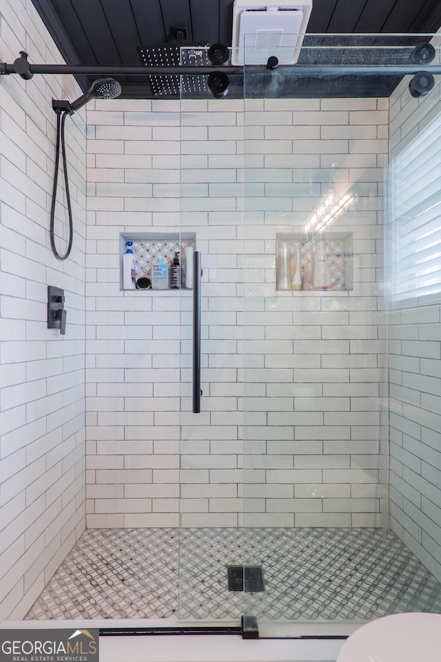 bathroom with toilet and a shower with shower door