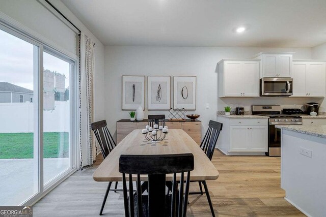 dining space featuring light hardwood / wood-style floors