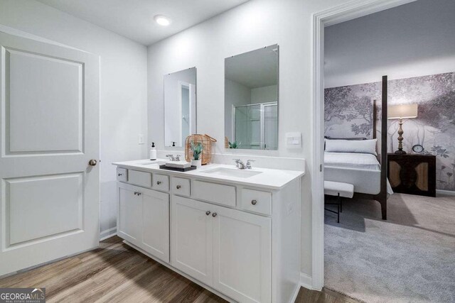 bathroom featuring vanity, a shower with shower door, and hardwood / wood-style floors