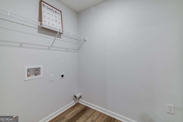 laundry area with electric dryer hookup, hookup for a washing machine, and dark wood-type flooring