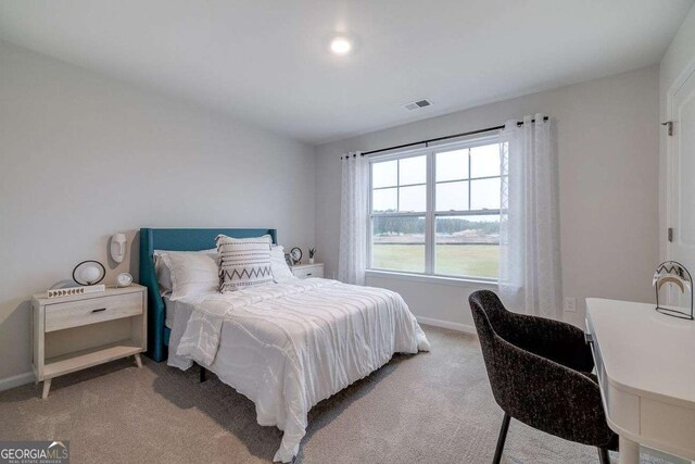 bedroom featuring light carpet