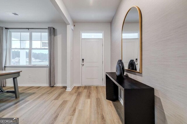 foyer entrance with plenty of natural light and light hardwood / wood-style floors