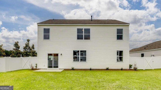 back of house featuring a patio and a lawn