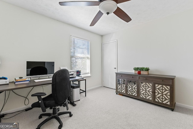 carpeted office space with ceiling fan