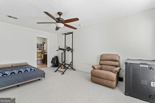 carpeted bedroom featuring ceiling fan and ensuite bath