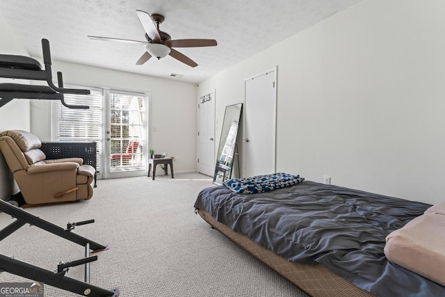 bedroom with carpet, a textured ceiling, and ceiling fan