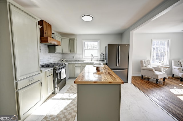 1202 Franklin Rd SW, Plainville, GA 30733 - kitchen with stainless steel appliances, wooden counters, a center island, gray cabinetry, and tasteful backsplash